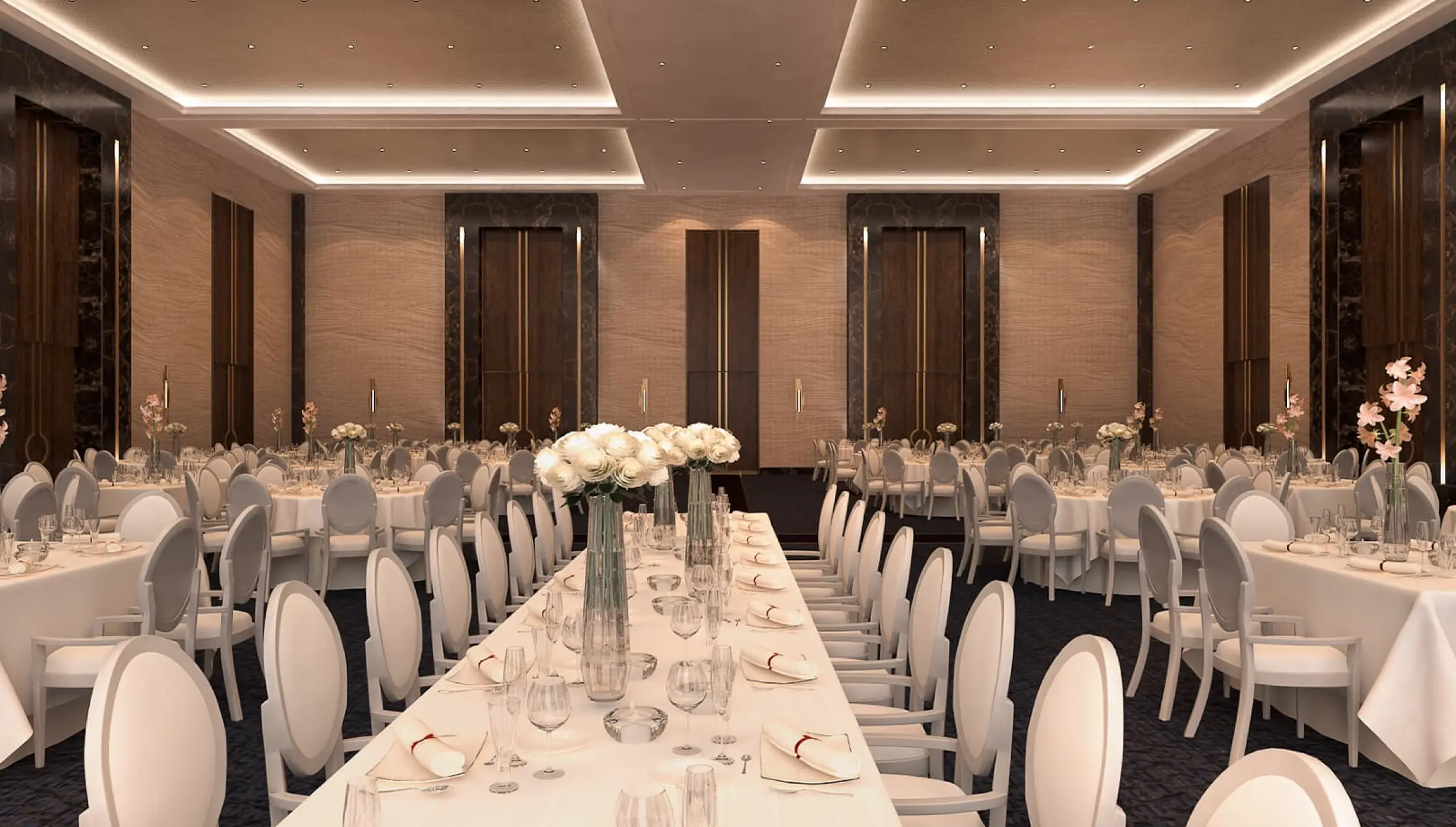 Blanc Sand Ballroom wedding reception setup with white floral centerpieces at Le Blanc Los Cabos