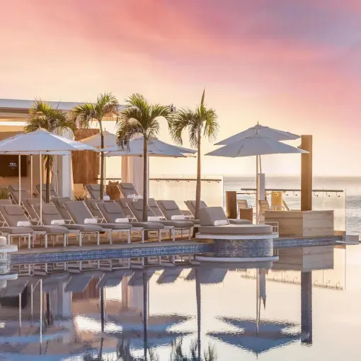 Le Blanc Los Cabos infinity pool with cabanas and lounge chairs at sunset, Cabo San Lucas