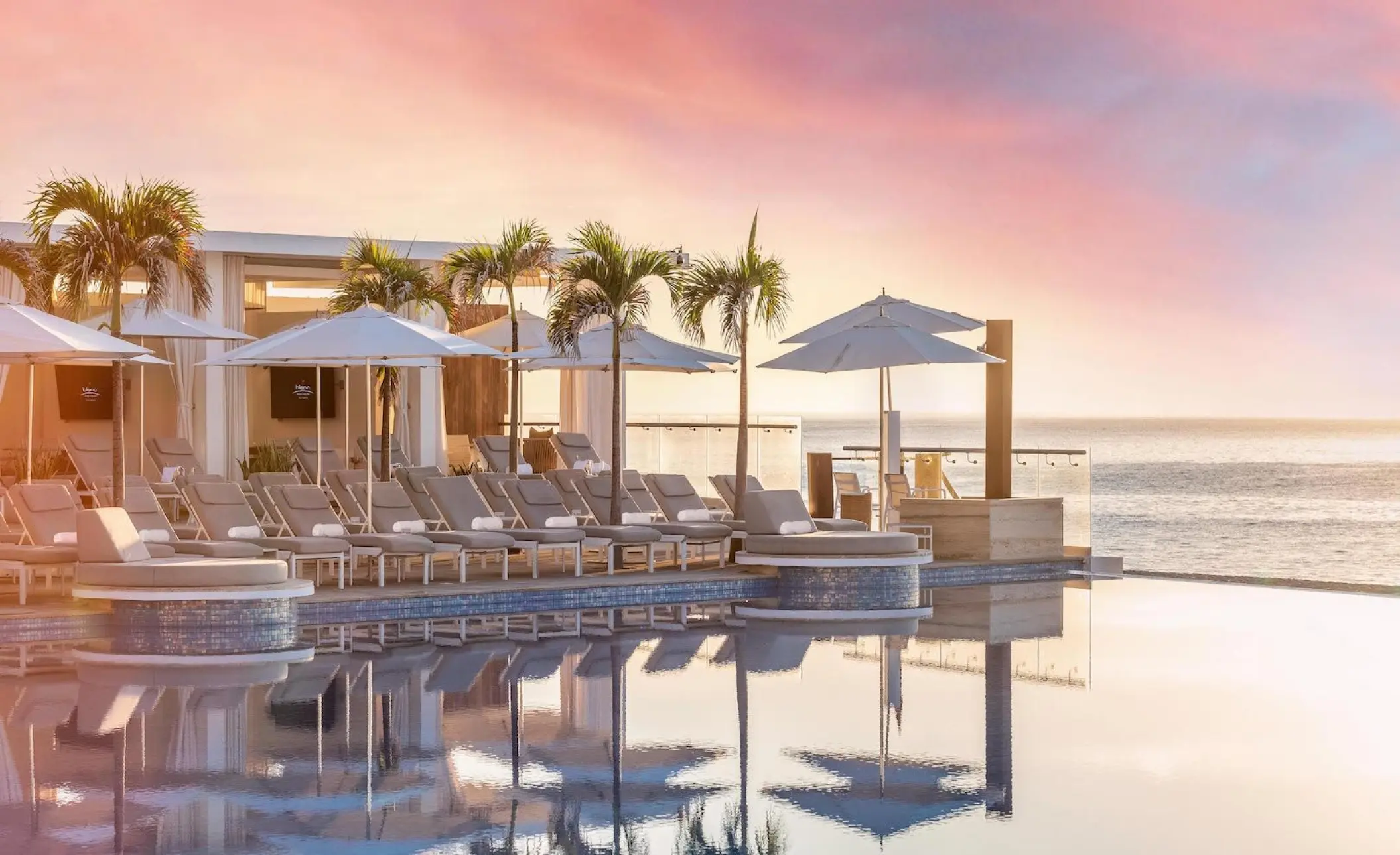 Le Blanc Los Cabos infinity pool with cabanas and lounge chairs at sunset, Cabo San Lucas