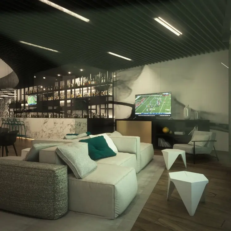 Modern sports bar with lounge seating and large screen at Live Aqua Beach Resort, Cancun