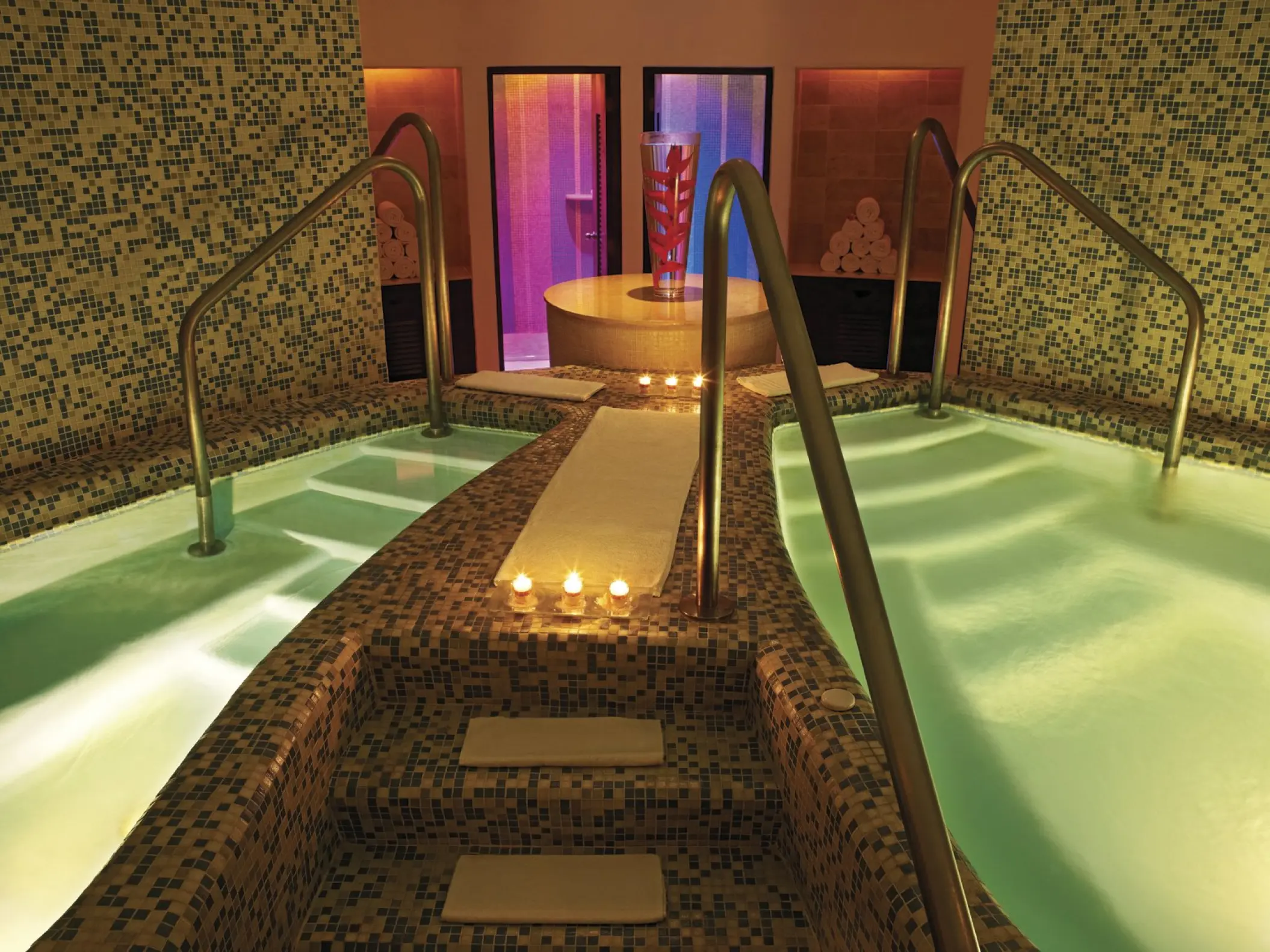 Indoor hydrotherapy pools with candles and mosaic tiling at Live Aqua Beach Resort, Cancun