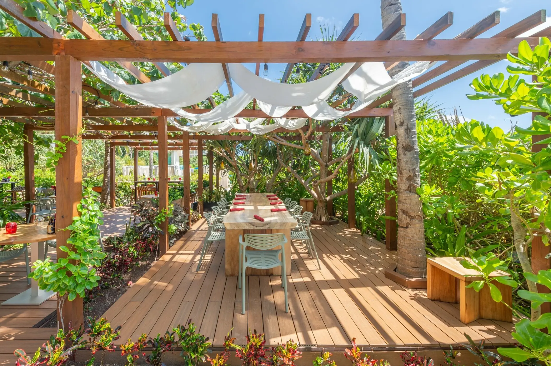 Outdoor wooden deck dining area at Live Aqua Beach Resort, Cancun
