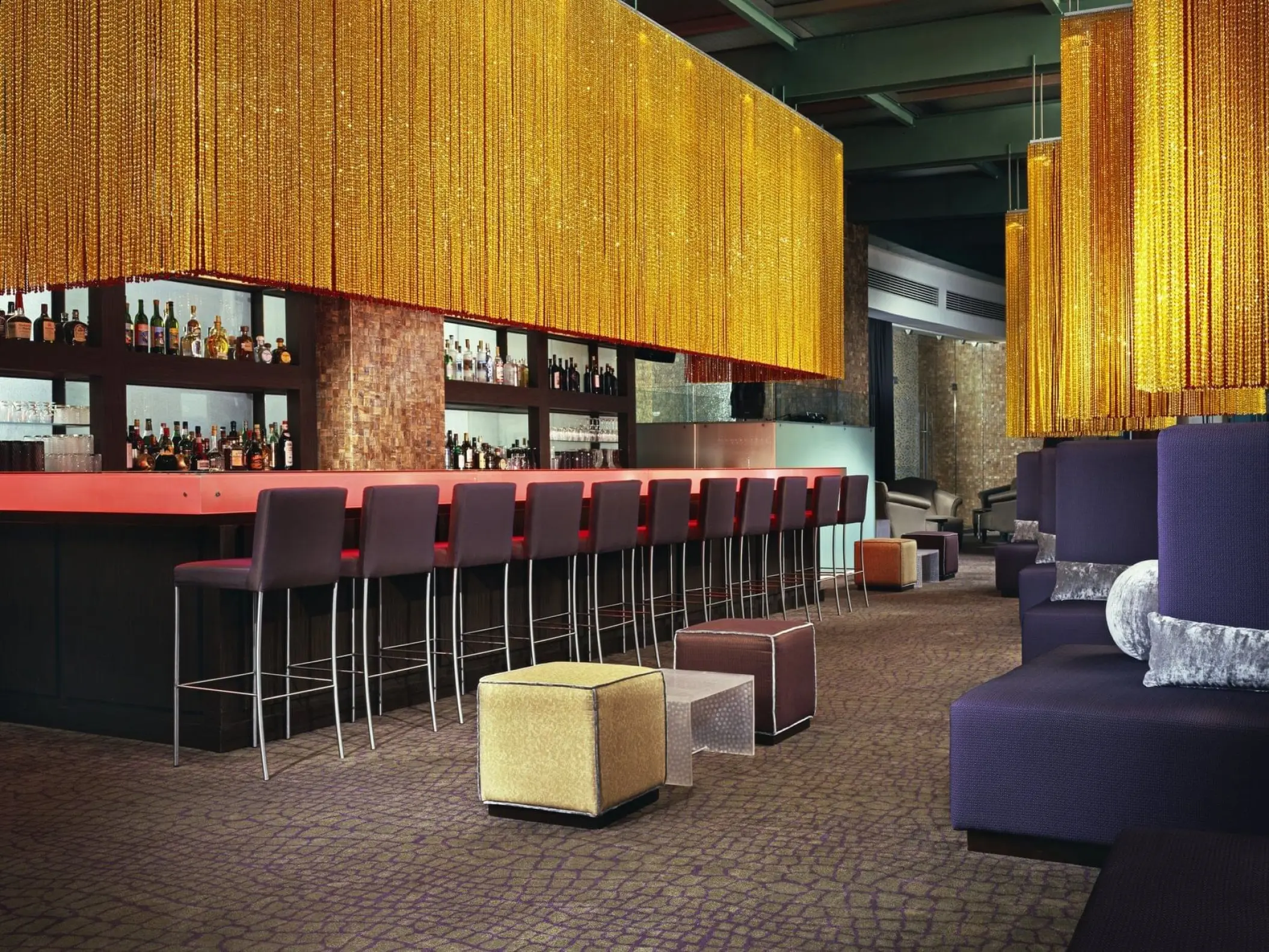 Egos Bar with gold fringe ceiling and purple lounge seating at Live Aqua Cancun