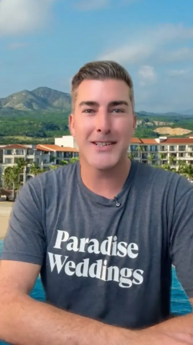 Paradise Weddings planner in a branded t-shirt speaking about Cabo wedding venues