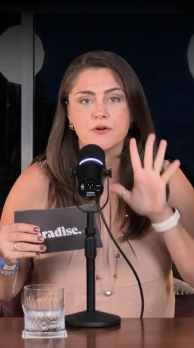 Paradise Weddings planner speaking into a microphone about Cancun and Riviera Maya destination weddings