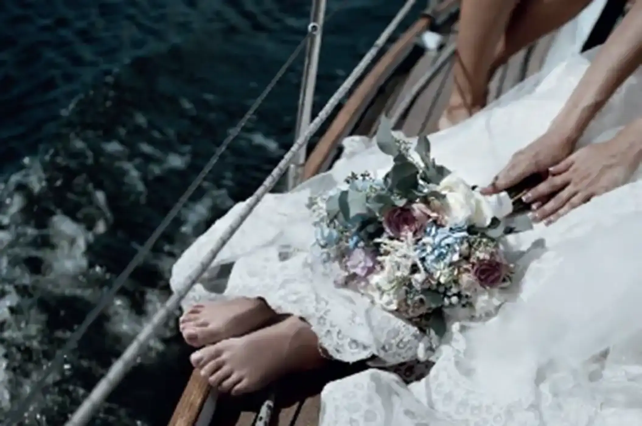 Bride sitting on a boat deck with her bouquet for a wedding ceremony at Paradisus Cancun