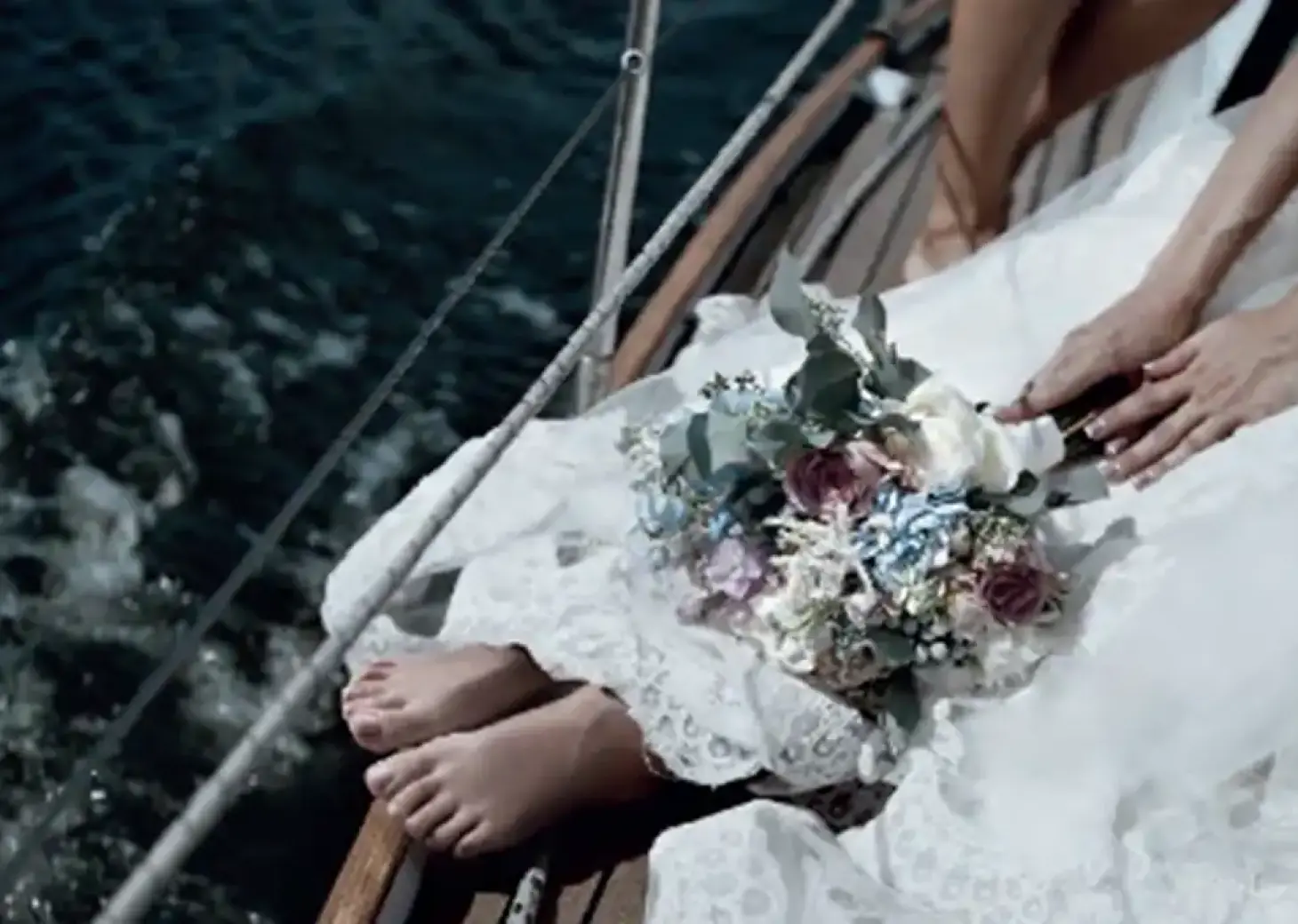 Bride sitting on a boat deck with her bouquet for a wedding ceremony at Paradisus Cancun