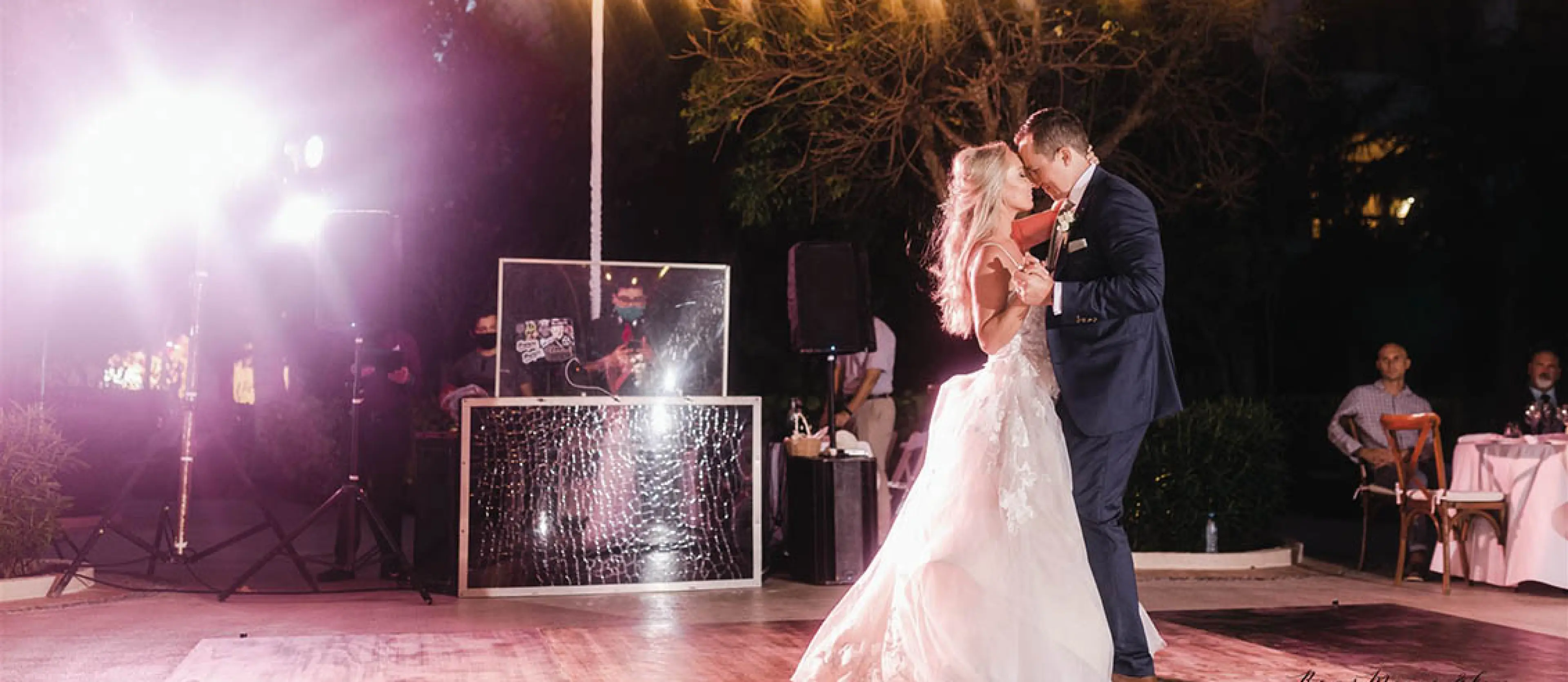 Lynsie and Chris dancing at their outdoor wedding reception under string lights