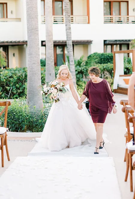 Bride with her mom walking down the isle