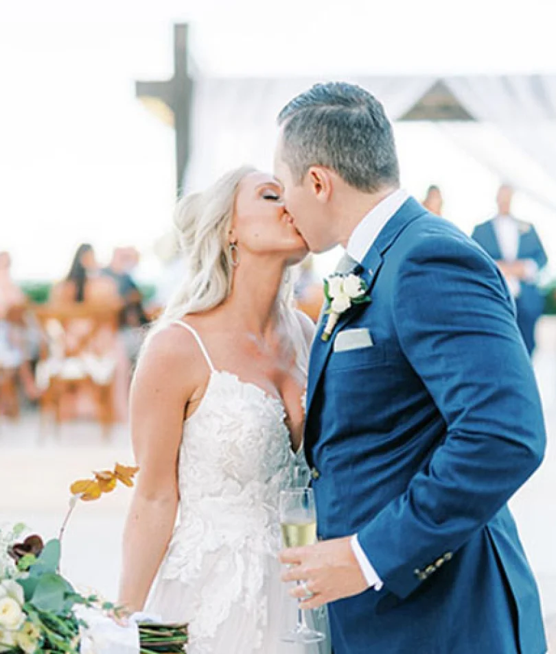 Bride kissing groom in front of the isle