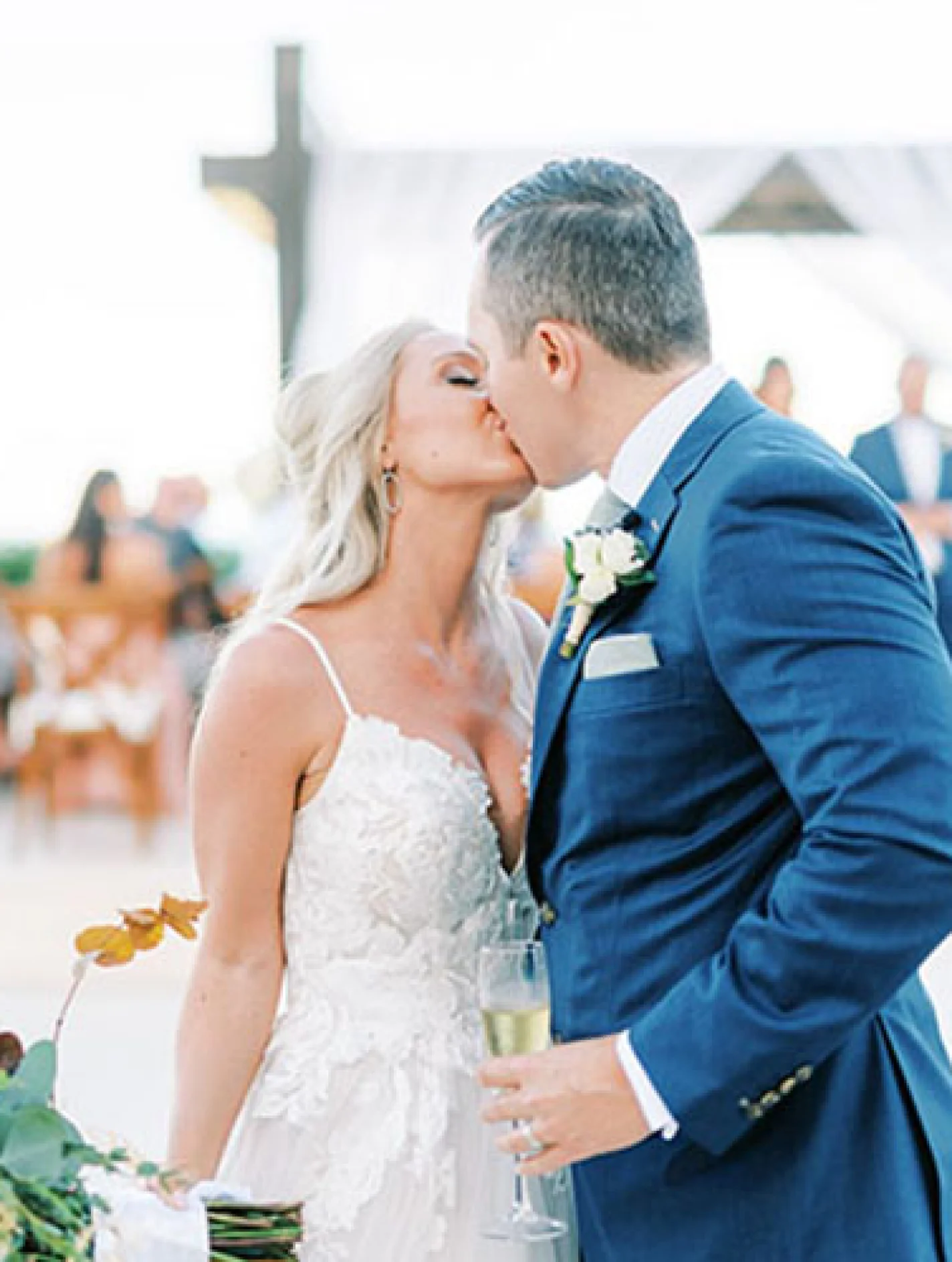 Bride kissing groom in front of the isle