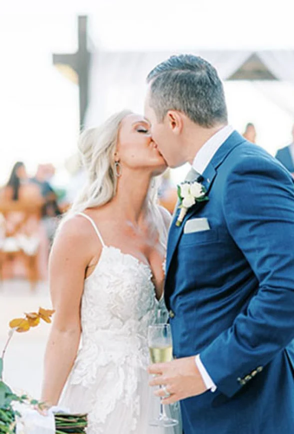 Bride kissing groom in front of the isle