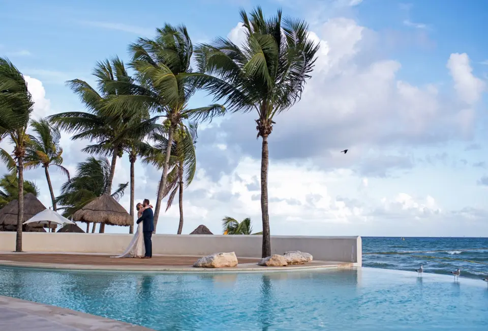 Couple next to the pool at Mahekal Beach Resort