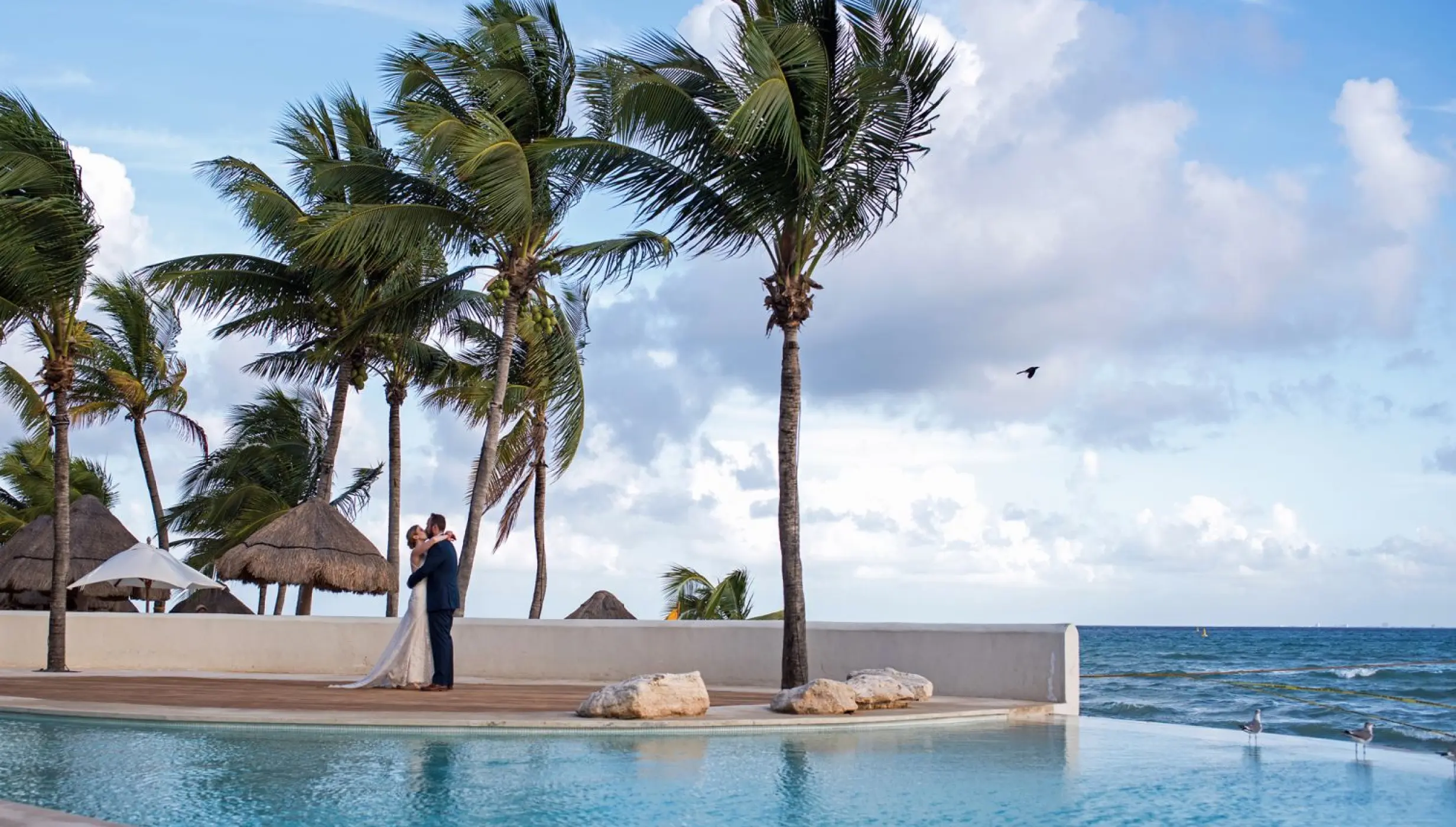 Couple next to the pool at Mahekal Beach Resort
