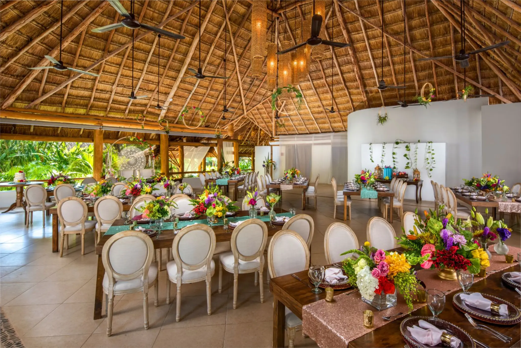 Indoor wedding reception under a thatched roof palapa at Mahekal Beach Resort, Playa Del Carmen