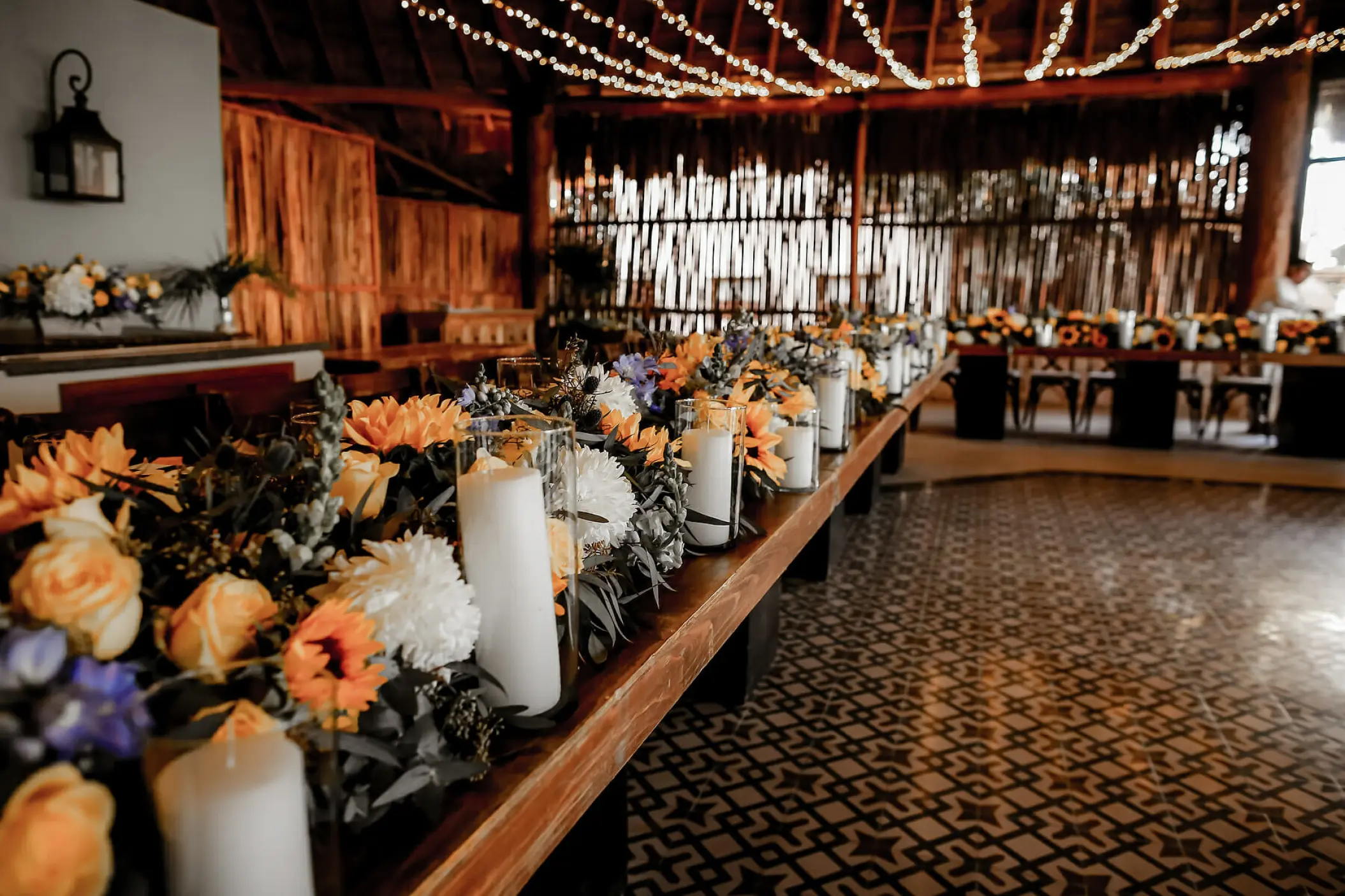 Wedding reception table with floral runner and candles at Mahekal Beach Resort, Playa Del Carmen