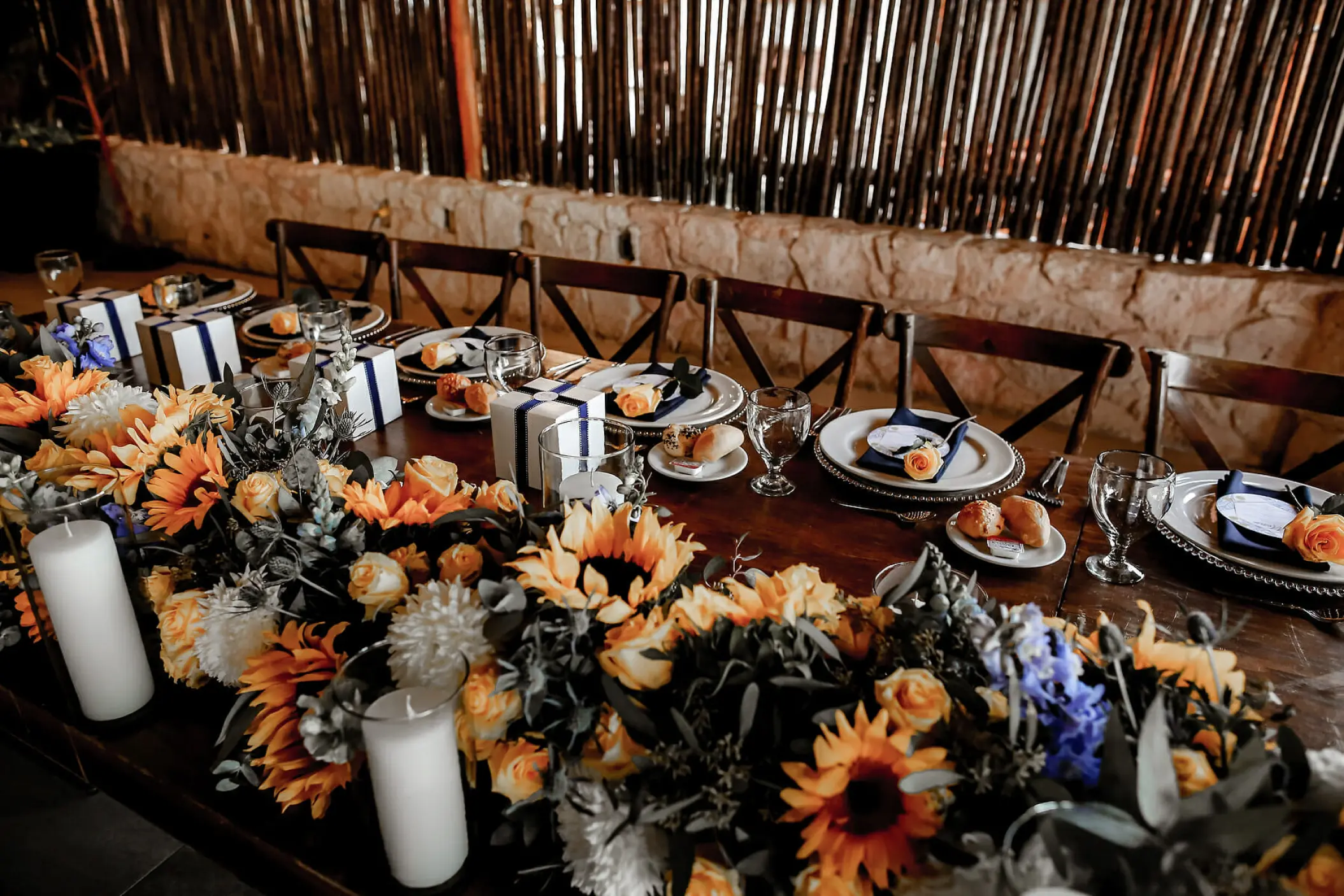 Wedding reception table with sunflowers and candles at Mahekal Beach Resort, Playa Del Carmen