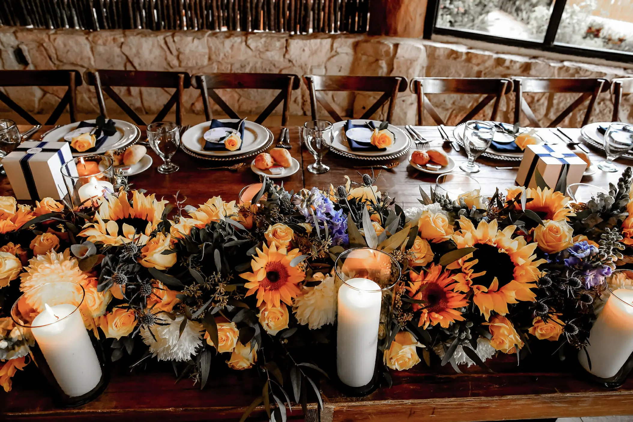 Sunflower and candle centerpiece for a wedding reception at Mahekal Beach Resort, Playa Del Carmen