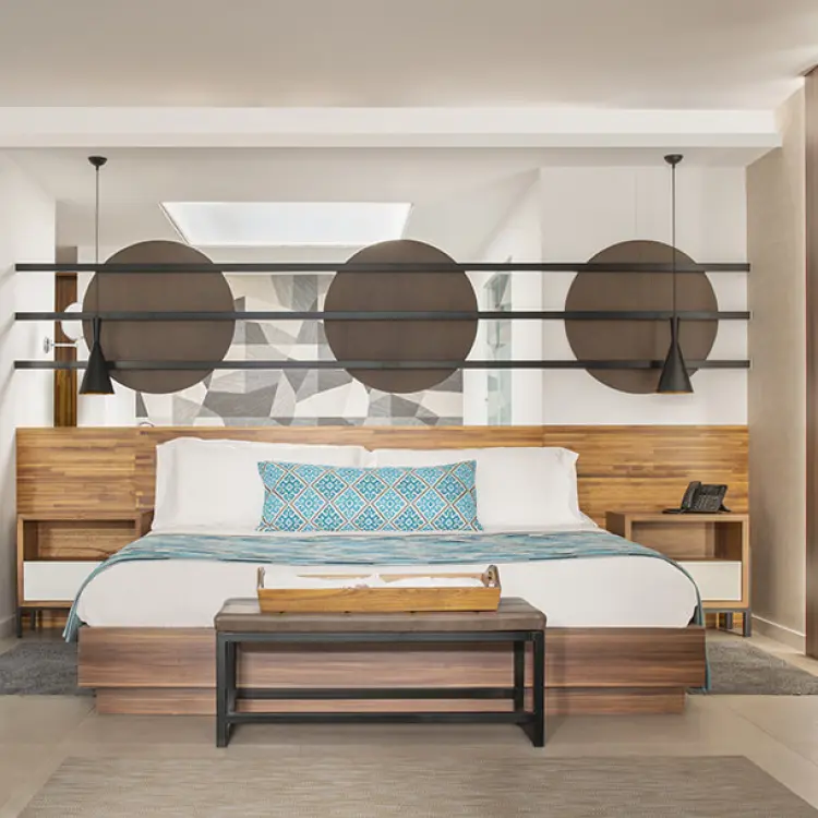 Modern suite bedroom with wooden accents and geometric decor at Majestic Elegance Costa Mujeres, Cancun