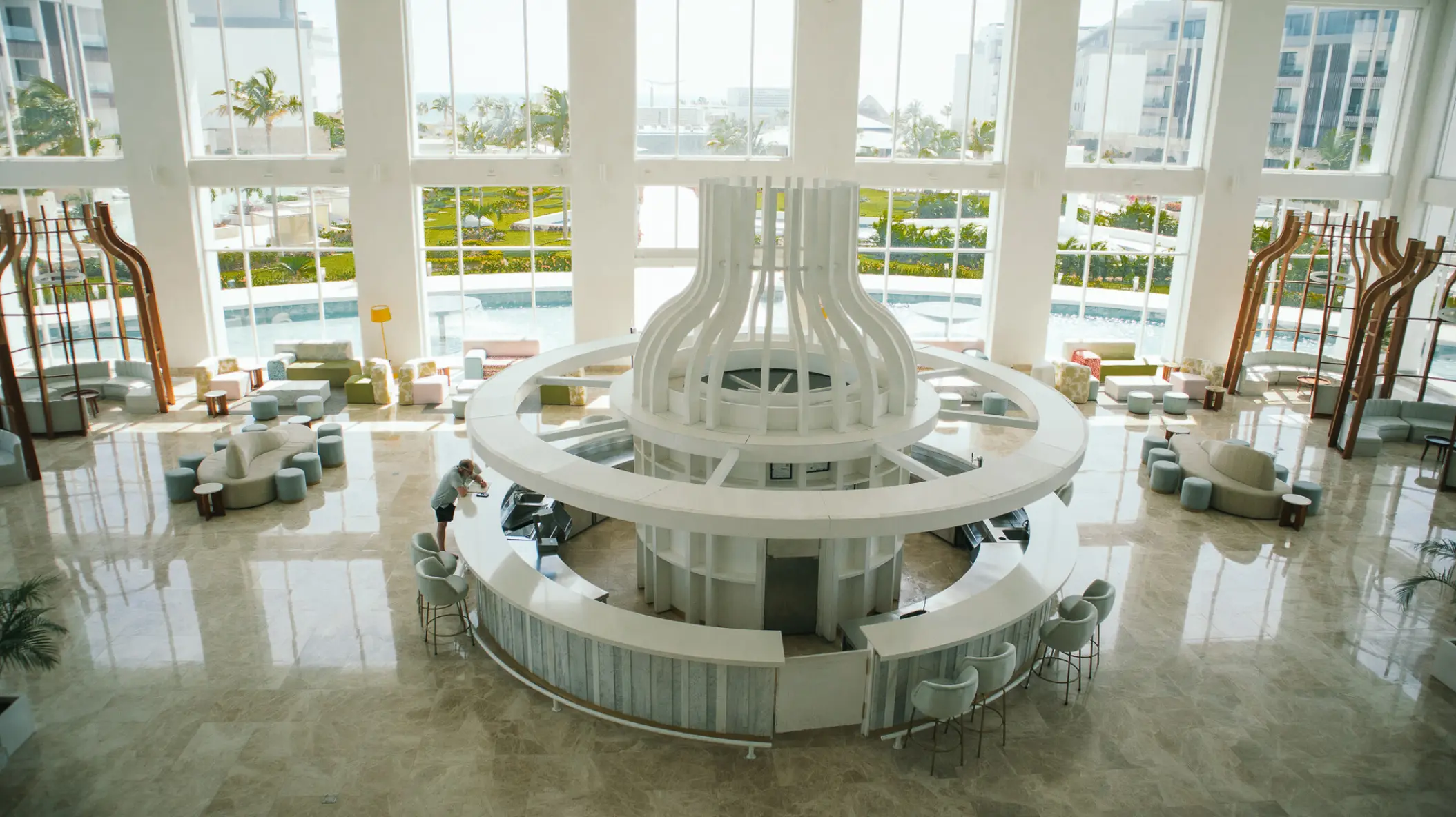 Modern circular lobby bar with white architecture at Majestic Elegance Costa Mujeres, Cancun