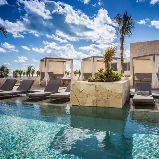 Poolside lounge chairs and cabanas at Majestic Elegance Costa Mujeres, Cancun