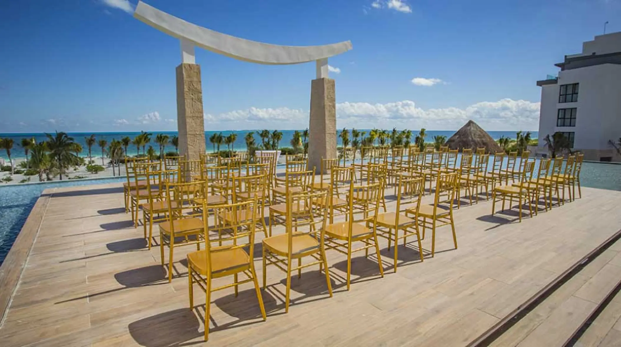 Sky wedding ceremony terrace with gold chairs at Majestic Elegance Costa Mujeres, Cancun