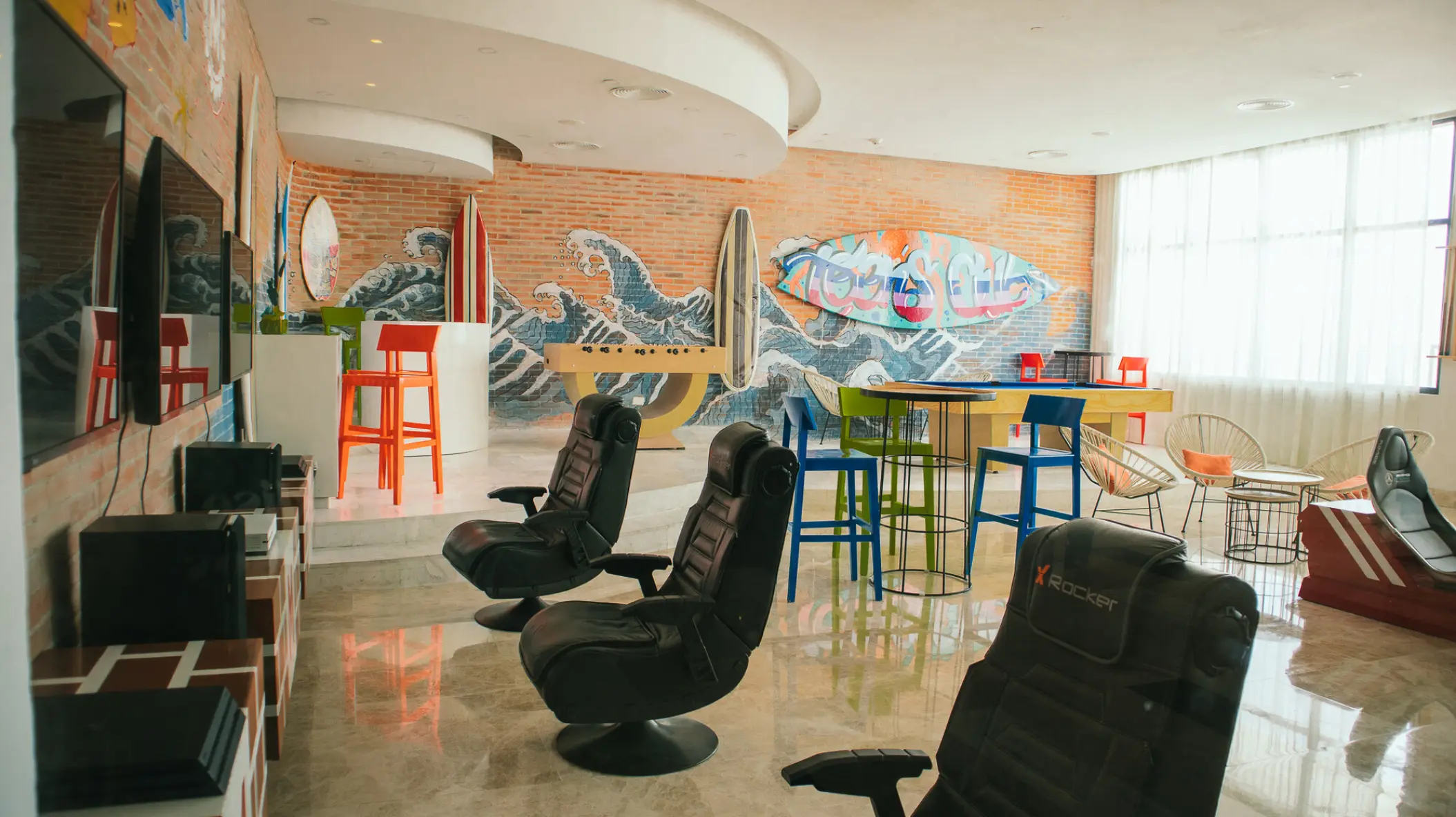 Teens club with gaming chairs and surf murals at Majestic Elegance Costa Mujeres, Cancun