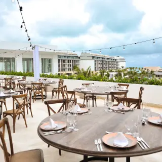 Outdoor wedding reception setup with string lights on the terrace at Majestic Elegance Costa Mujeres, Cancun