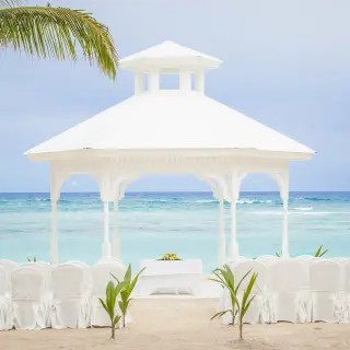 White beach gazebo wedding ceremony setup at Majestic Elegance, Punta Cana