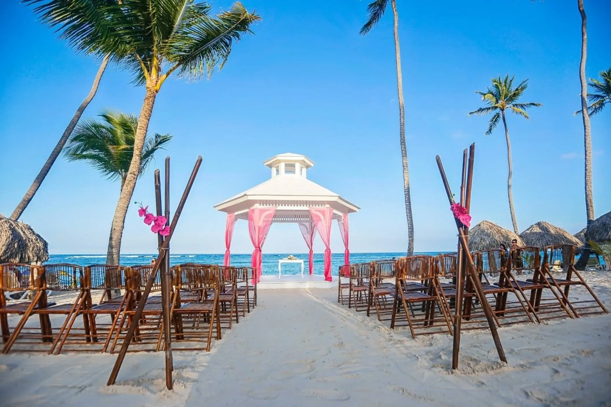 Beachfront wedding ceremony gazebo with pink drapes at Majestic Elegance, Punta Cana