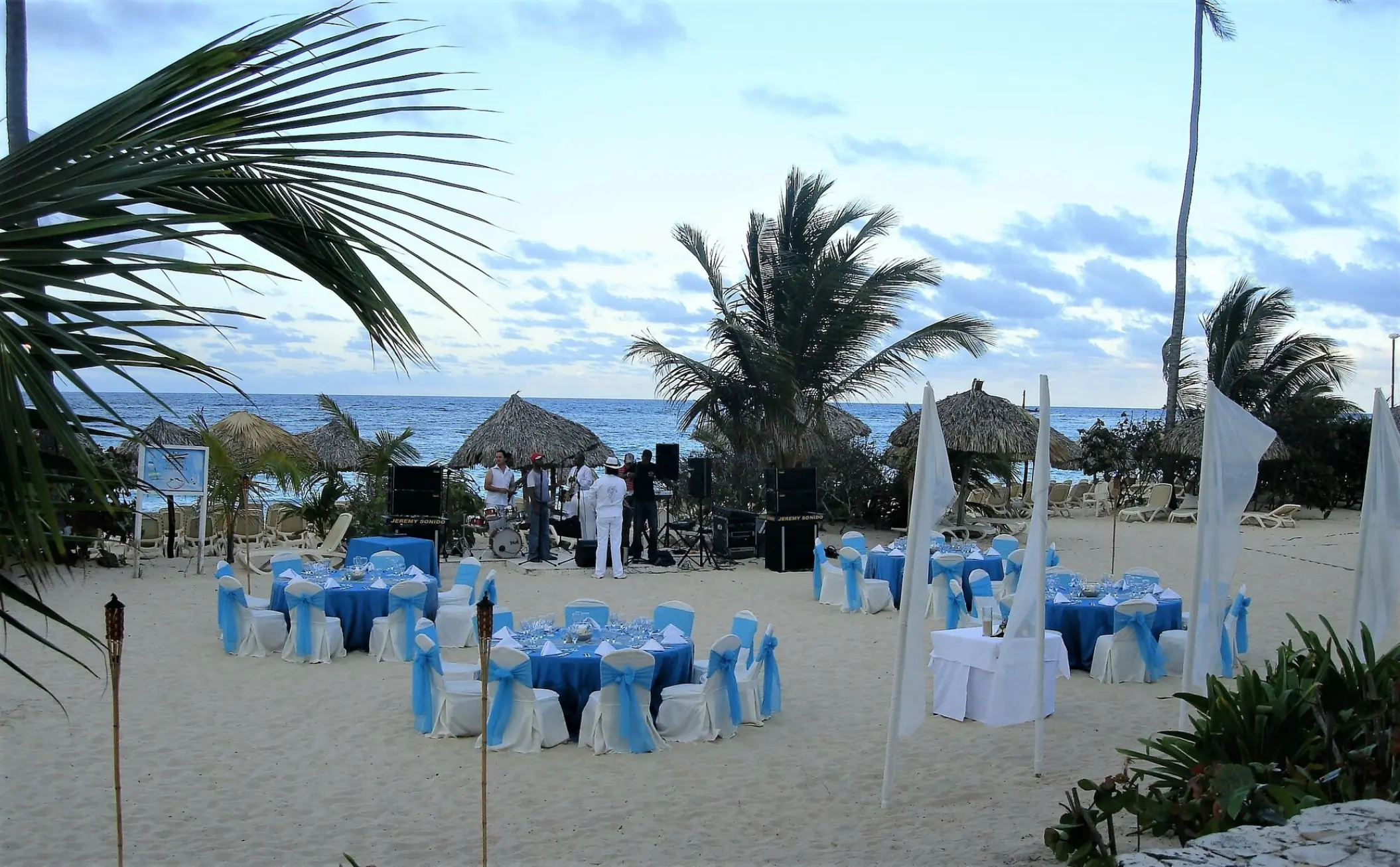 Beachfront wedding reception with blue and white tables at Majestic Elegance, Punta Cana
