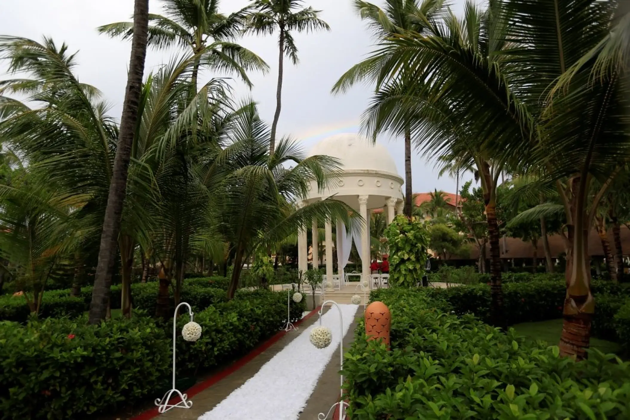 Garden gazebo wedding ceremony setup with white aisle runner at Majestic Elegance Punta Cana