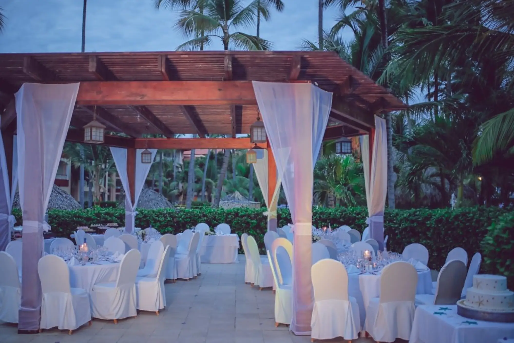Outdoor wedding reception setup under a wooden gazebo at Majestic Elegance Punta Cana