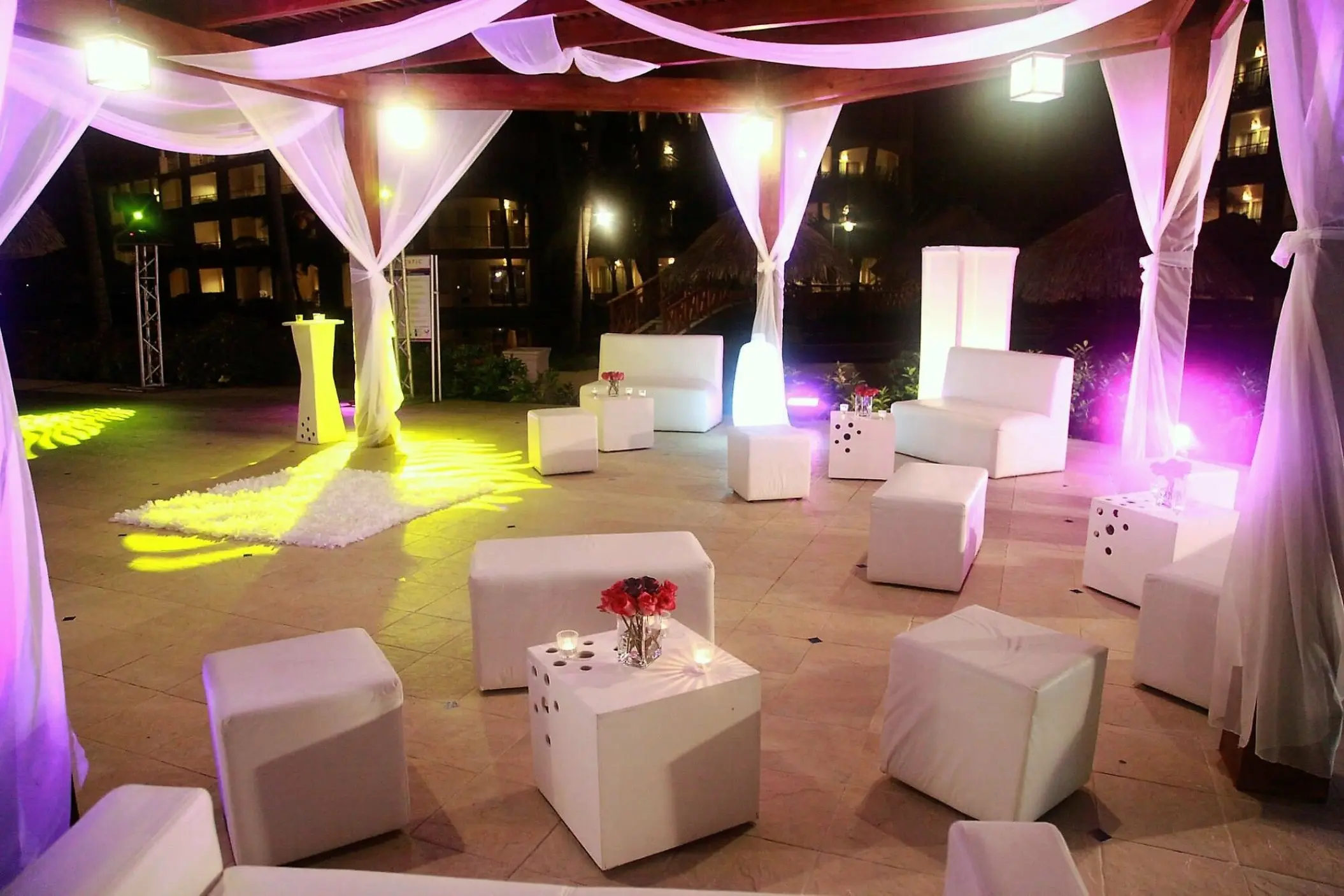Outdoor wedding reception lounge area with white furniture under a canopy at Majestic Elegance Punta Cana