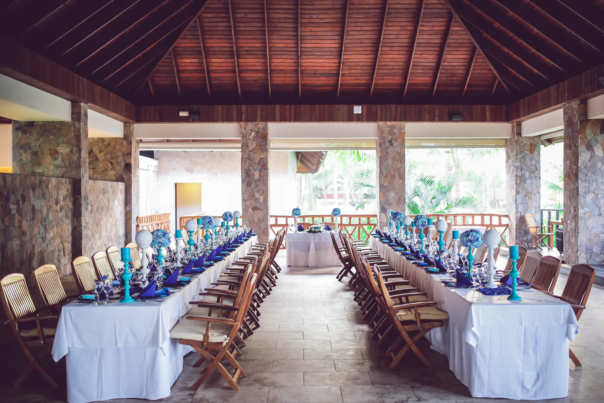 Wedding reception setup under a wooden pavilion at Majestic Elegance, Punta Cana