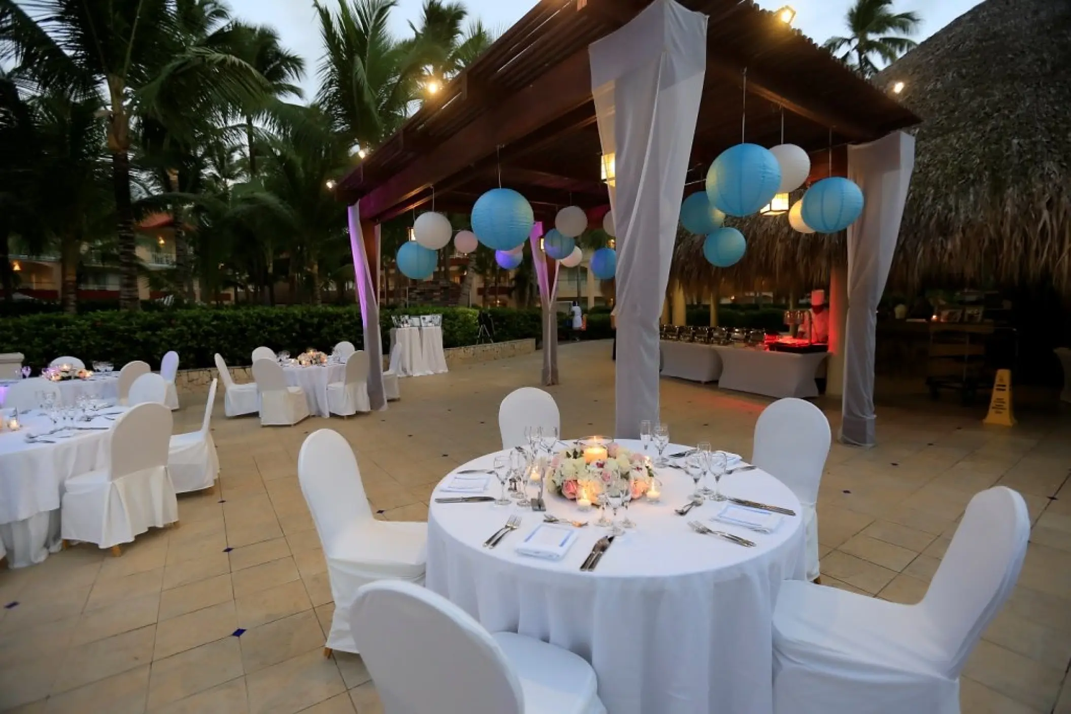 Outdoor wedding reception with paper lanterns and white linens at Majestic Elegance, Punta Cana
