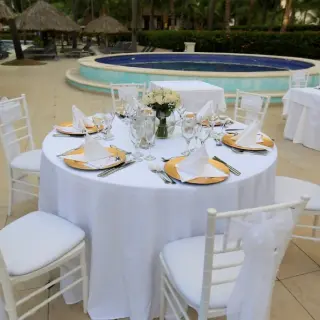 Wedding reception table setup poolside at Majestic Elegance Punta Cana