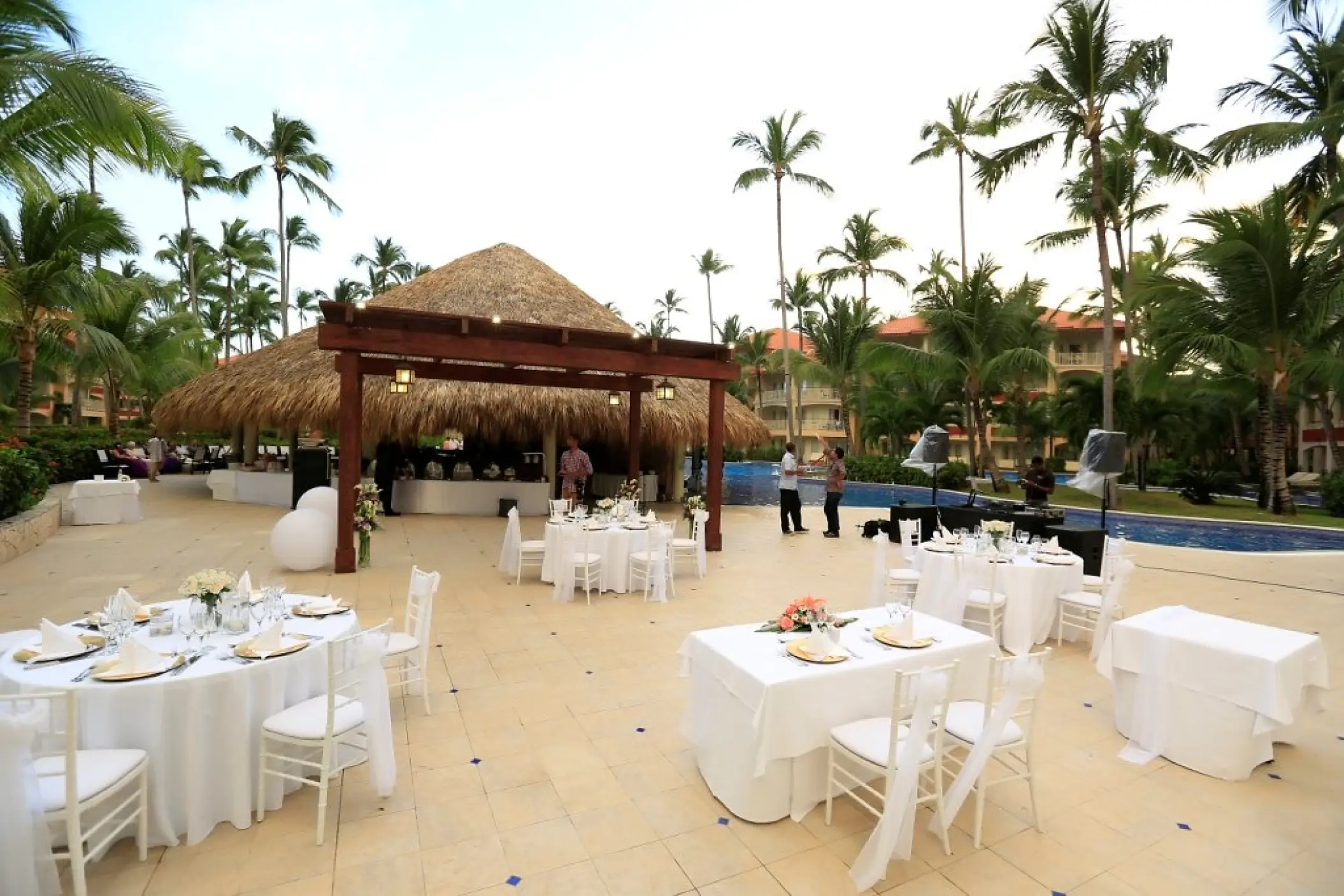 Outdoor wedding reception setup with white tables and chairs at Majestic Elegance, Punta Cana