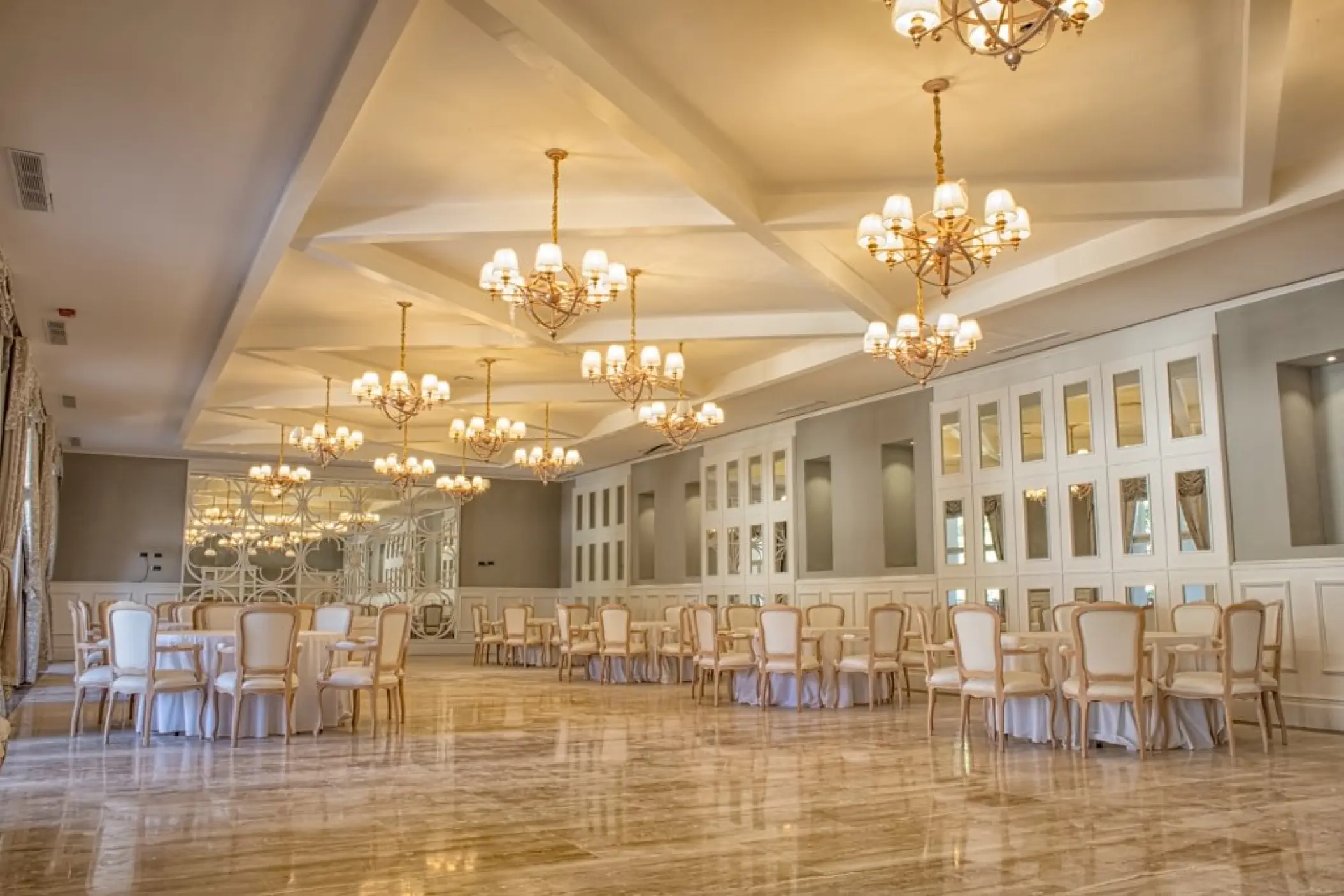 Indoor ballroom wedding reception with gold chandeliers at Majestic Mirage, Punta Cana