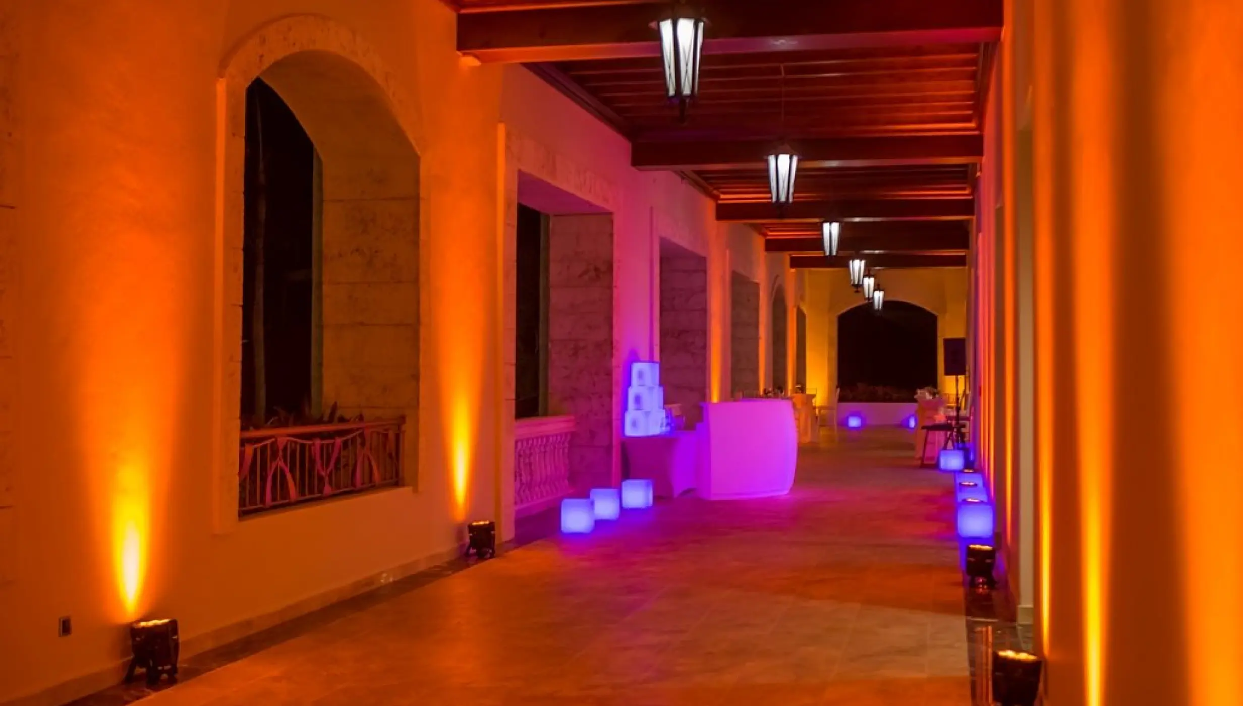 Ballroom terrace wedding reception with orange and purple event lighting at Majestic Mirage, Punta Cana