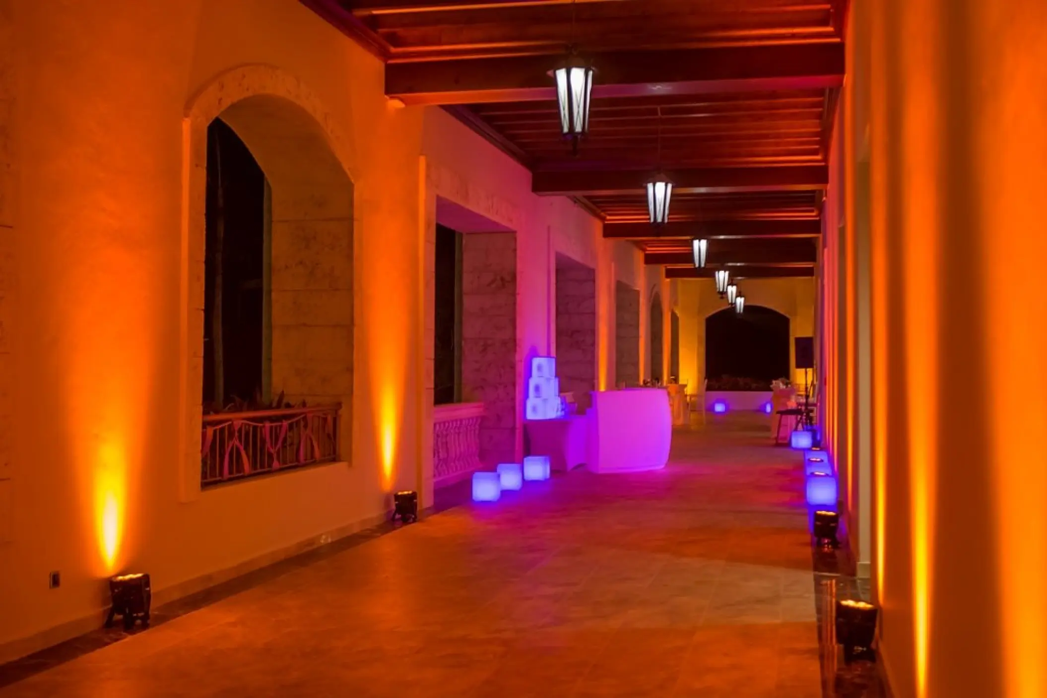 Ballroom terrace wedding reception with orange and purple event lighting at Majestic Mirage, Punta Cana