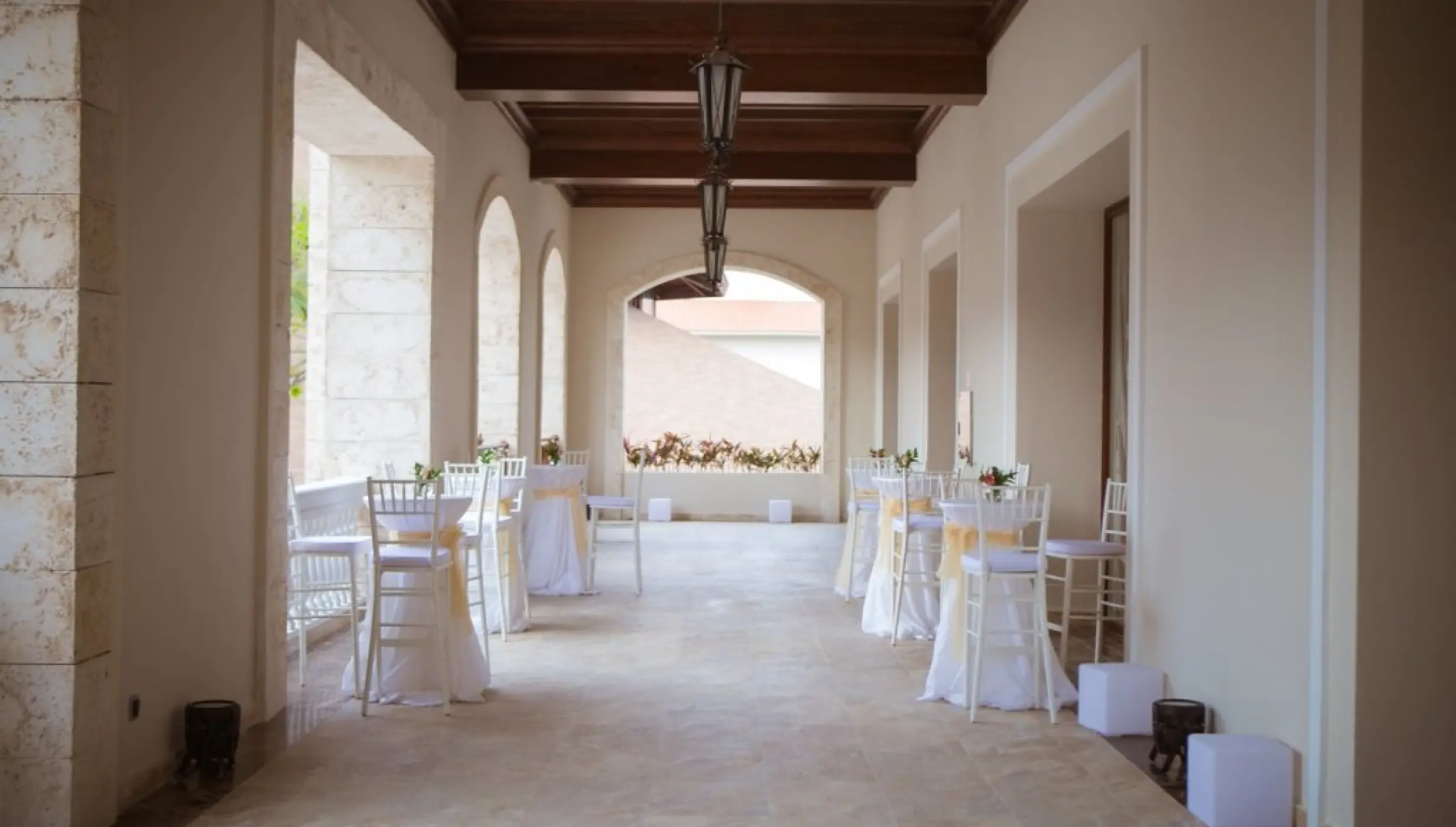 Covered ballroom terrace with cocktail tables at Majestic Mirage, Punta Cana
