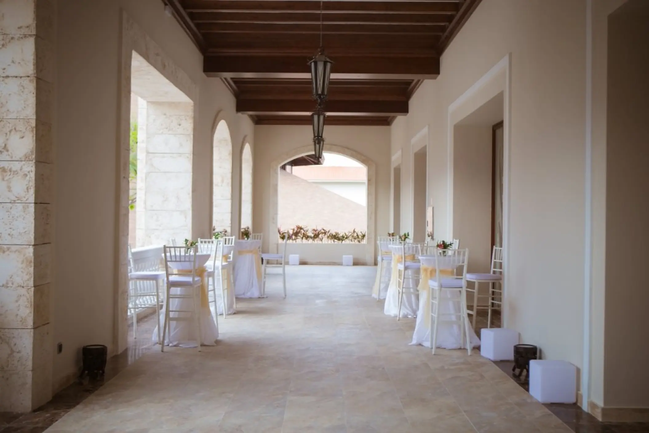 Covered ballroom terrace with cocktail tables at Majestic Mirage, Punta Cana