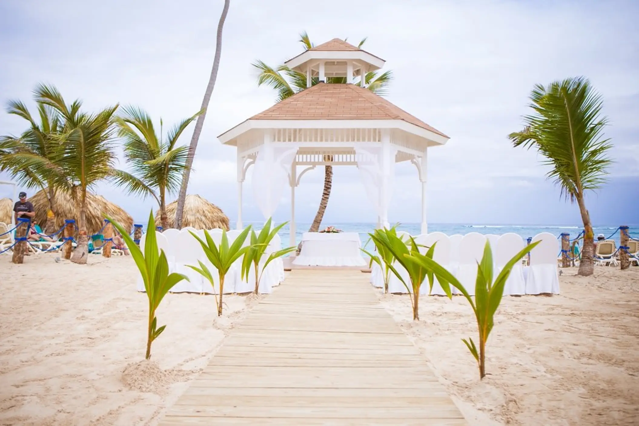 Beachfront wedding ceremony gazebo with a wooden aisle at Majestic Mirage, Punta Cana