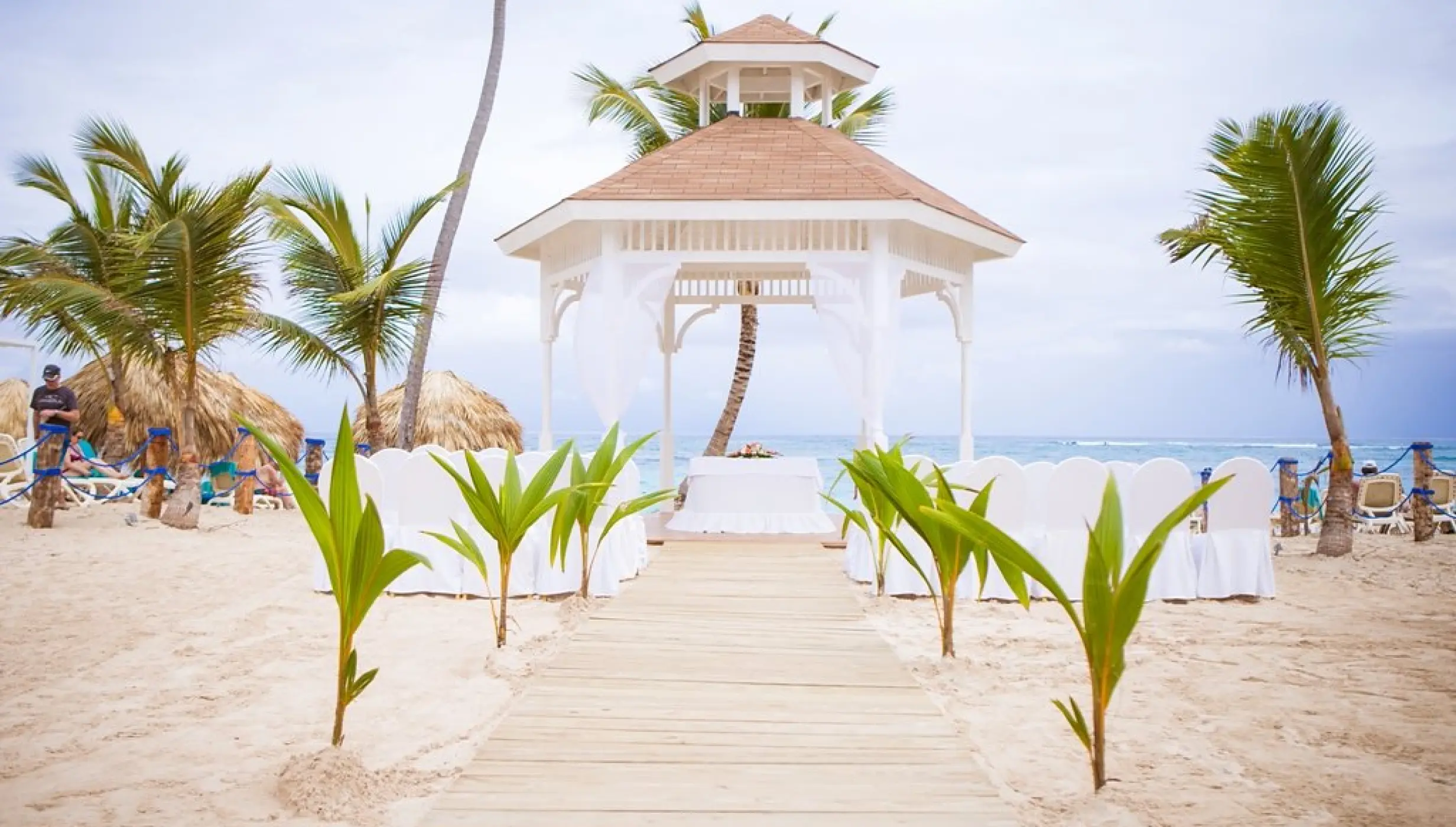 Beachfront wedding ceremony gazebo with a wooden aisle at Majestic Mirage, Punta Cana