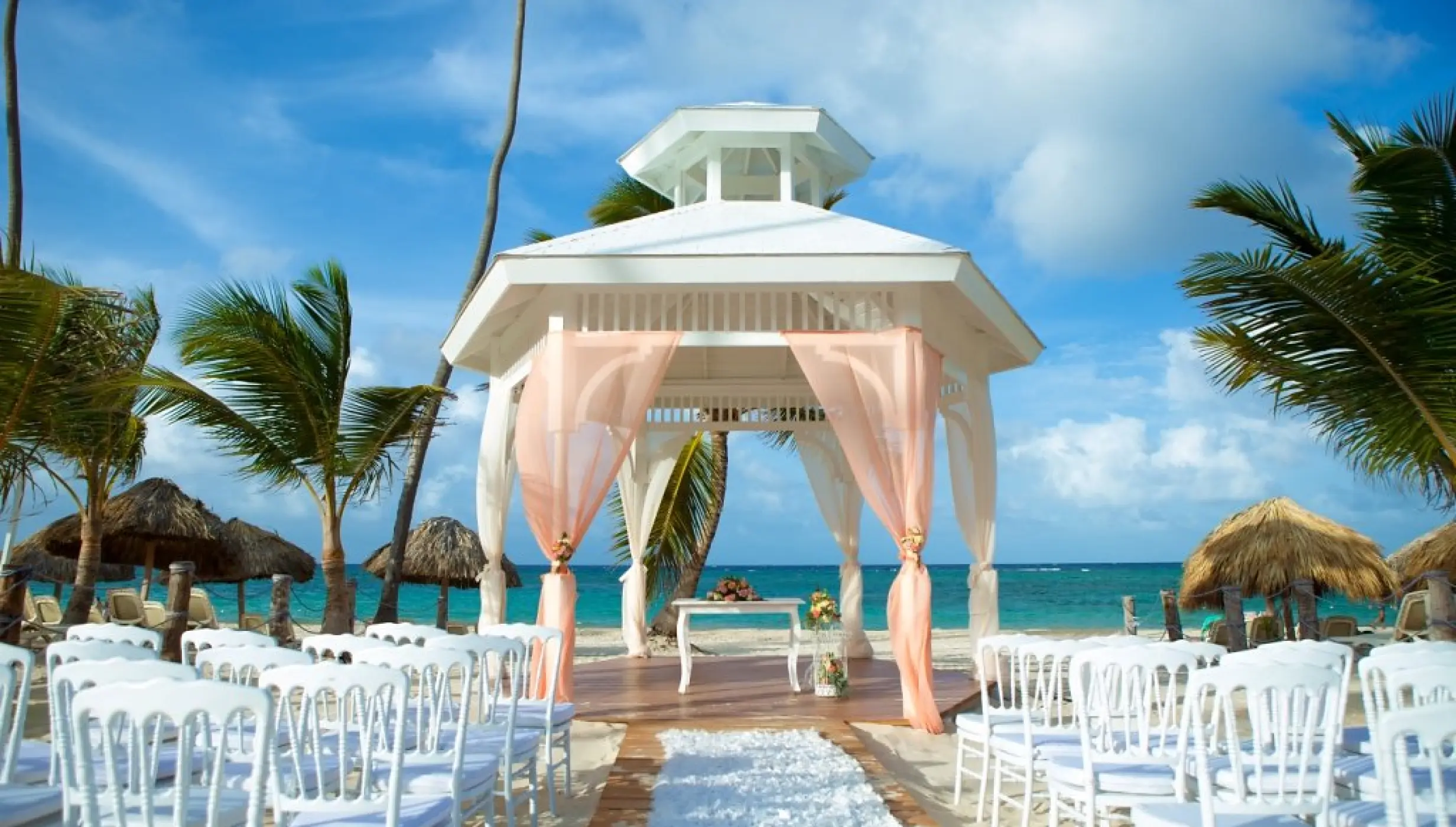 Beachfront wedding ceremony gazebo with pink drapes at Majestic Mirage, Punta Cana