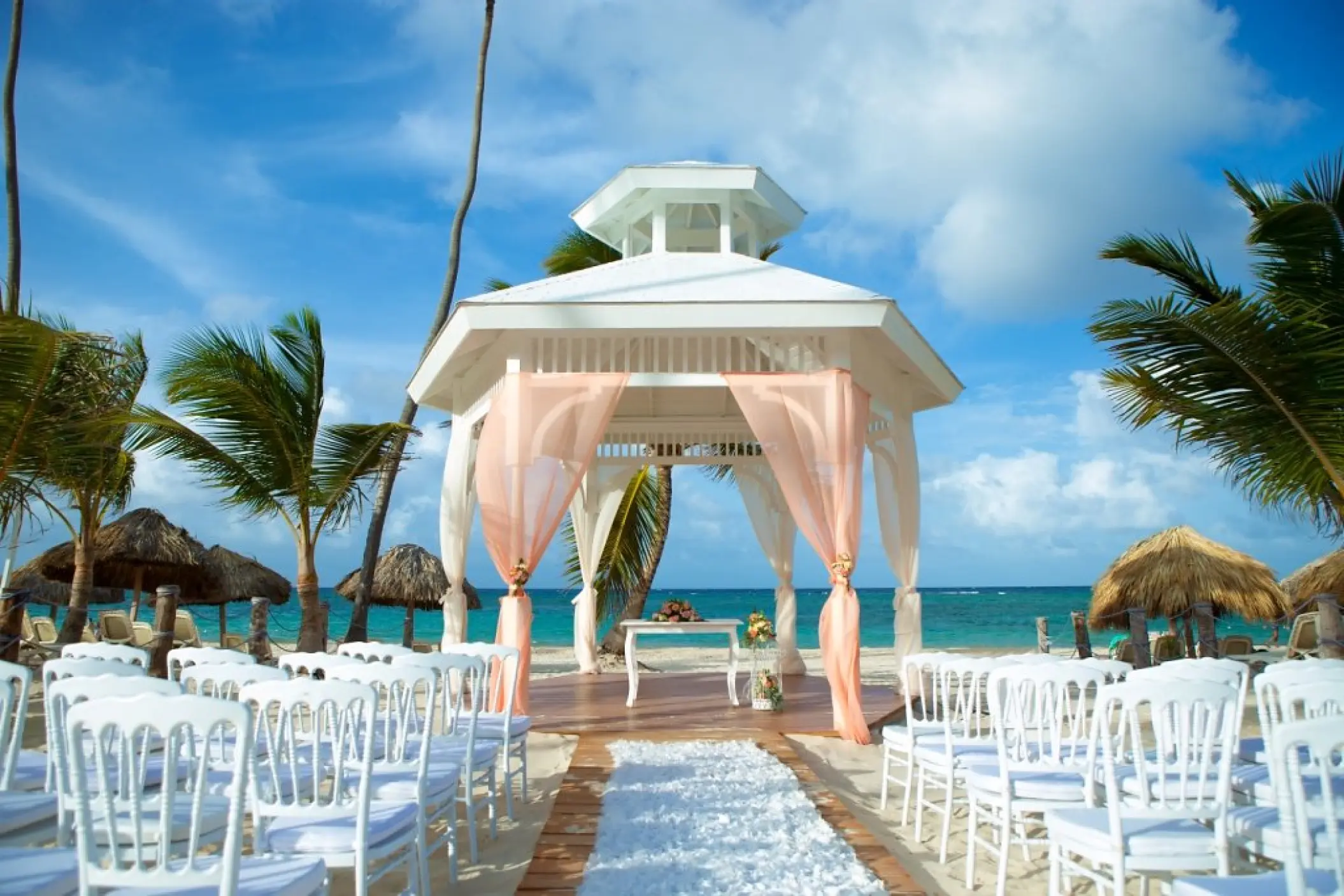 Beachfront wedding ceremony gazebo with pink drapes at Majestic Mirage, Punta Cana