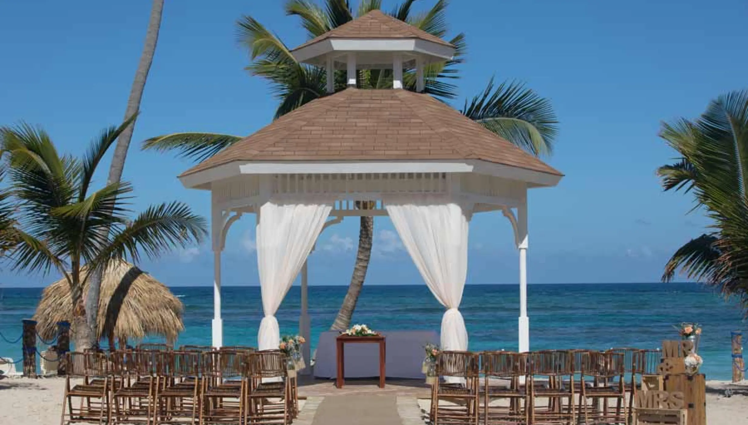 Beachfront wedding ceremony gazebo with white drapes at Majestic Mirage, Punta Cana