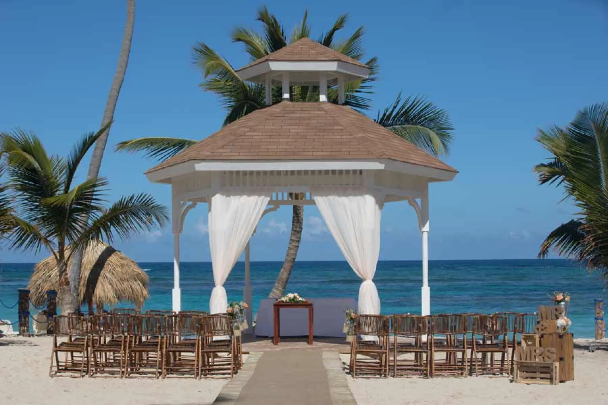 Beachfront wedding ceremony gazebo with white drapes at Majestic Mirage, Punta Cana