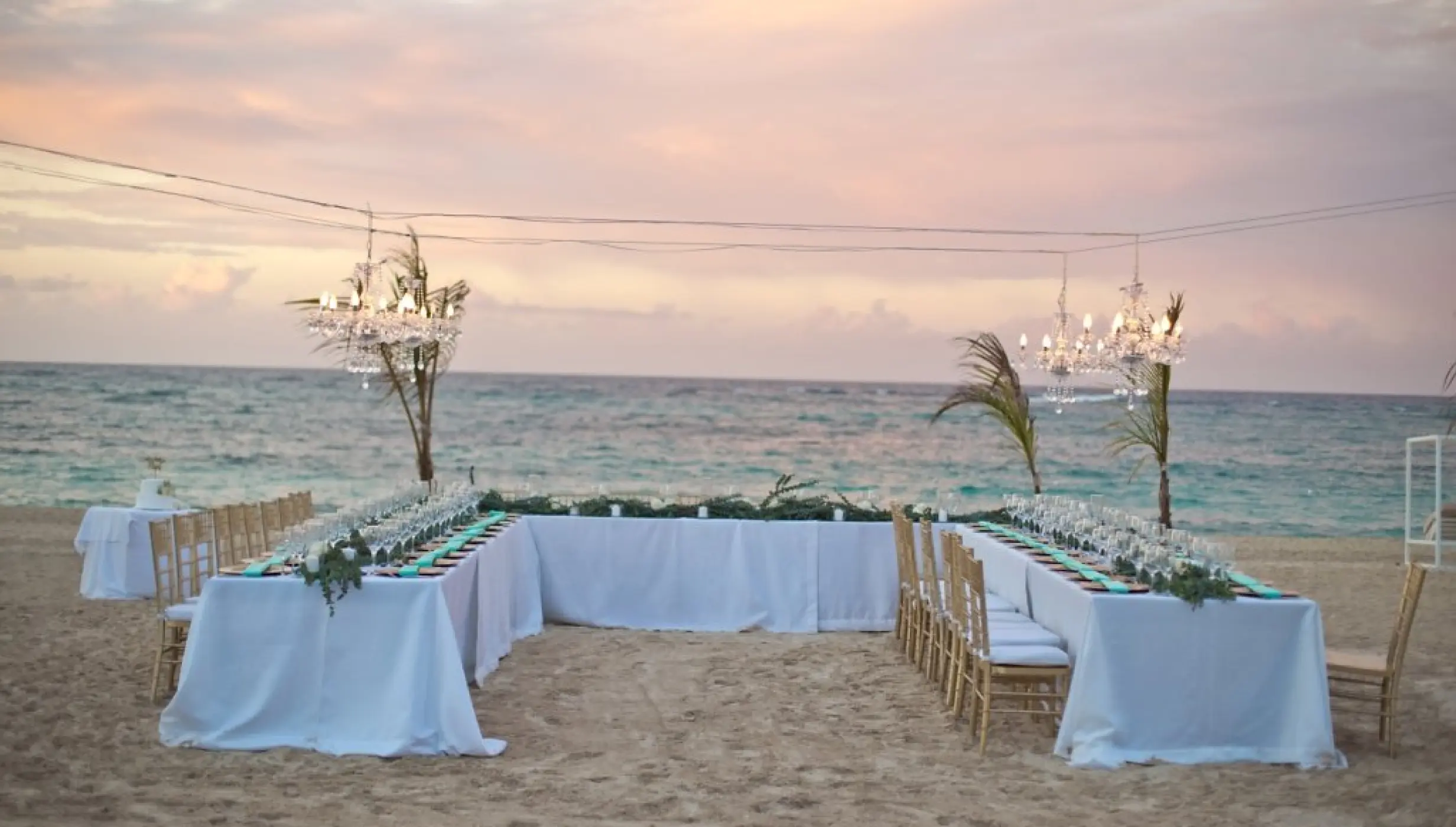 Beachfront wedding reception setup with chandeliers at Majestic Mirage Punta Cana
